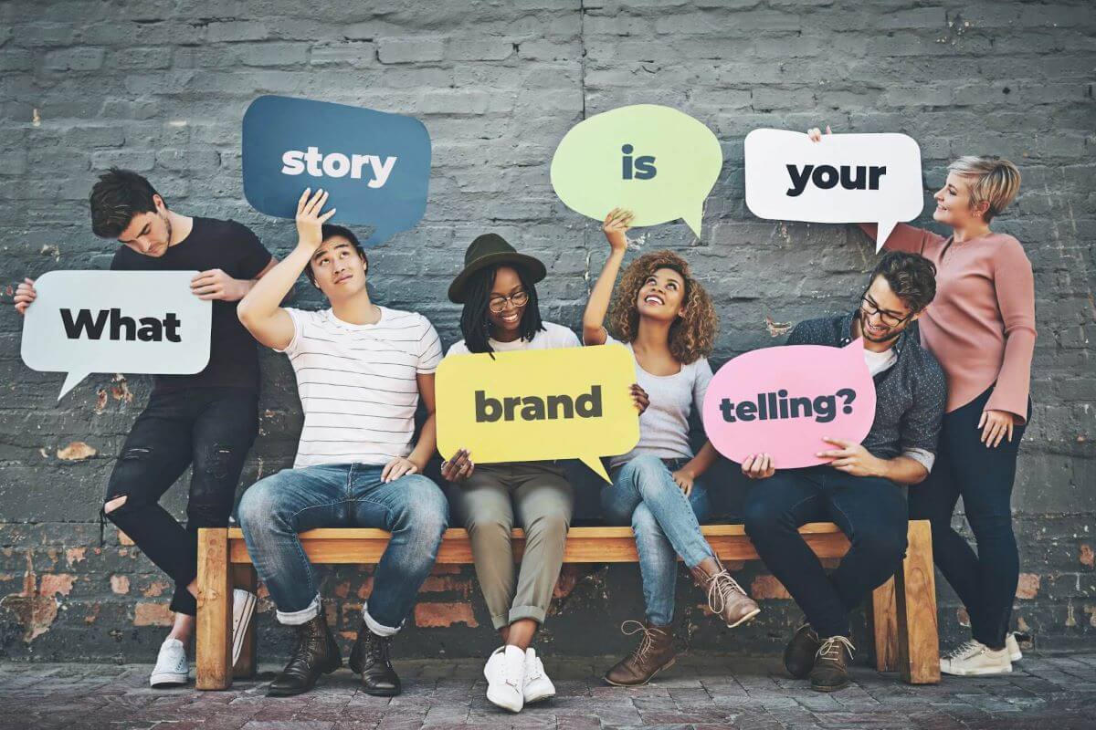 Stock photo of various people holding up signs that spell out, "What story is your brand telling?"